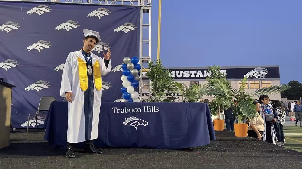 Abubakr Elmallah walking the stage at Trabuco Hills High School graduation